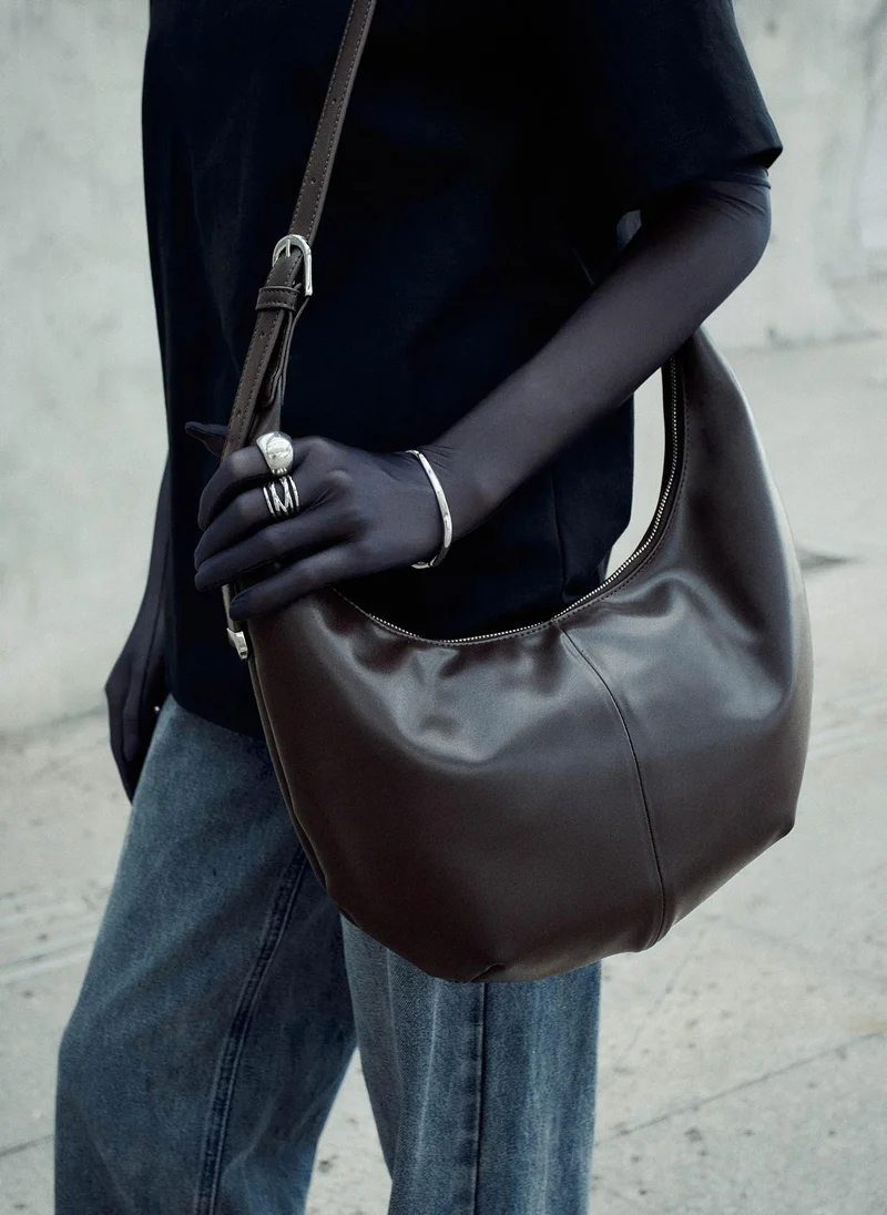 Semi-circular bag with long shoulder strap
