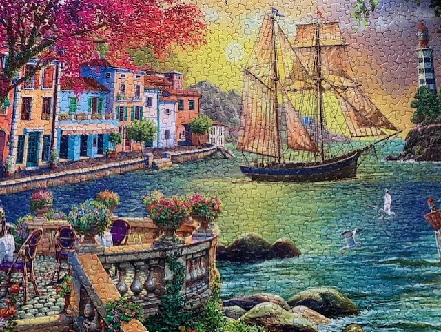 Springbok - Oceanside Sunset - 1000 Piece Jigsaw Puzzle Illustration of Villa on Waters Edge with Ship Sailing in - Image 3