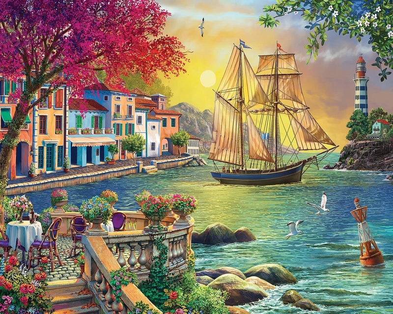 Springbok - Oceanside Sunset - 1000 Piece Jigsaw Puzzle Illustration of Villa on Waters Edge with Ship Sailing in - Image 1