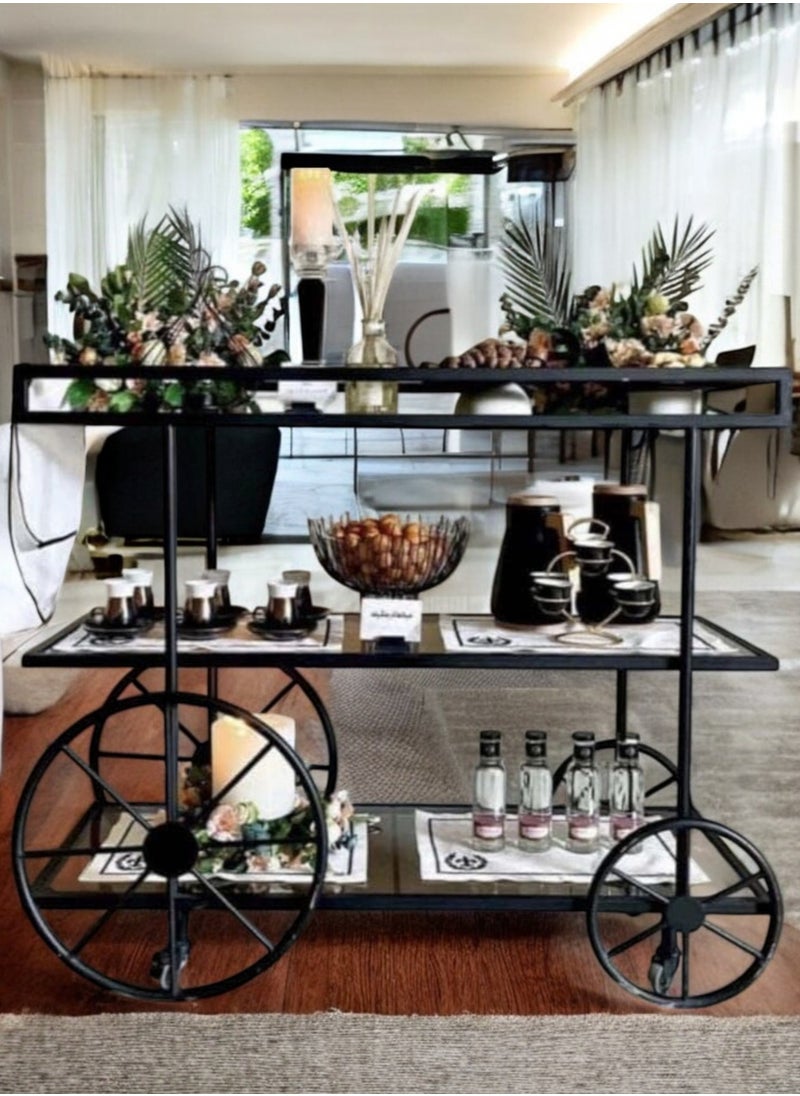 Black Cycle Serving Trolley with 4 Tiers, featuring a modern design and clear glass for perfect display. It can be easily used in kitchens, restaurants, hotels, chalets and homes, making it a distinctive and valuable addition to any occasion, (100 cm length, 90 cm height, 40 cm width)