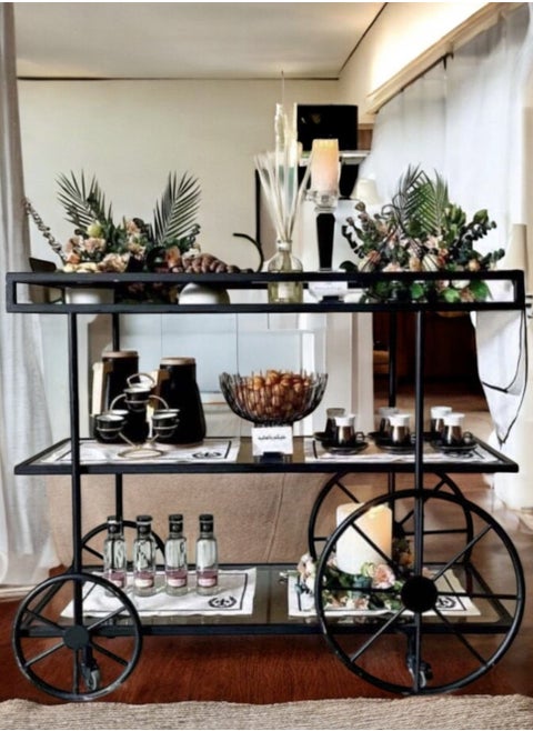 Black Cycle Serving Trolley with 4 Tiers, featuring a modern design and clear glass for perfect display. It can be easily used in kitchens, restaurants, hotels, chalets and homes, making it a distinctive and valuable addition to any occasion, (100 cm length, 90 cm height, 40 cm width)