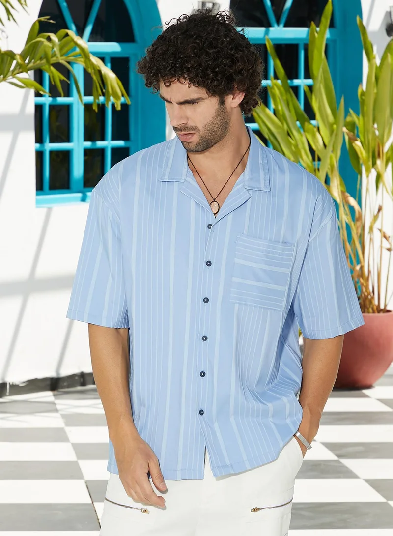 Campus Sutra Campus Sutra Men's Powder Blue Unbalanced-Ridge Oversized Shirt For Casual Wear | Spread Collar | Short Regular Sleeves | Button Closure | Oversized Shirt Crafted With Comfort Fit For Everyday Wear
