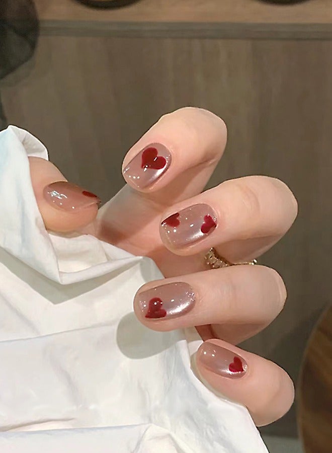 NIBEMINENT 24 قطعة أظافر صناعية، أظافر صناعية في علبة، أظافر صناعية قصيرة ومسطحة على شكل رأس قطة بلون بشرة صلبة لامعة، رقعة أظافر صناعية على شكل قلب وردي أحمر - Image 1