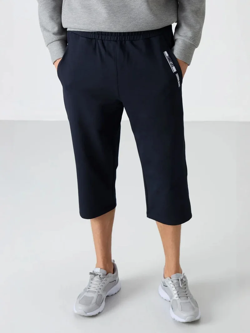 تومي لايف TOMMY Men's Mid-Waist Capri Shorts