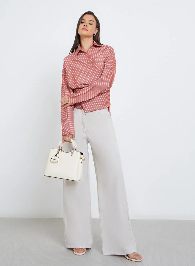 ستايلي بلوزة مخططة بأكمام وطواطية بنمط لف