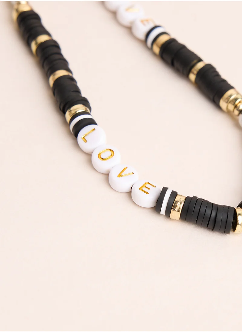 COCONUT LANE Black And Gold Phone Strap