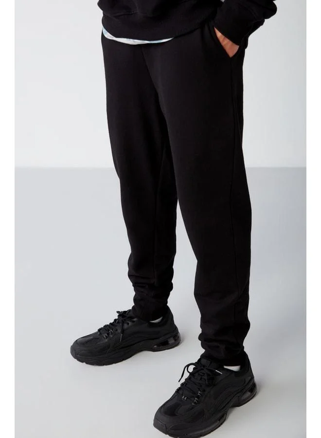GRIMELANGE Jeremiah Men's Regular Fit Pants with Stretch Fabric, Waist Drawstring, and Elastic Pocket, Black Sweatpants.