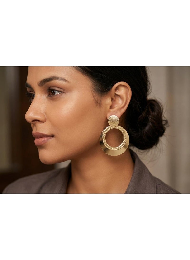 Luxuria These earrings feature a geometric design that combines a narrow top disc and a large circular hoop with engraved or etched details, giving them a classic yet modern touch. - Image 1