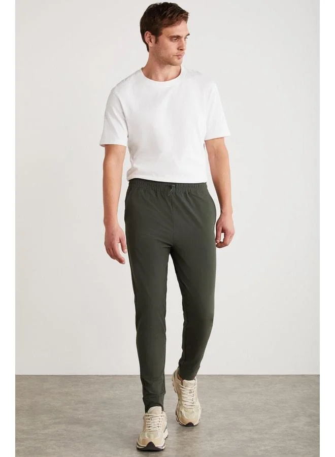 GRIMELANGE Christian Men's Elastic Waist and Stopper-Detail Technical Fabric Green Sweatpants.