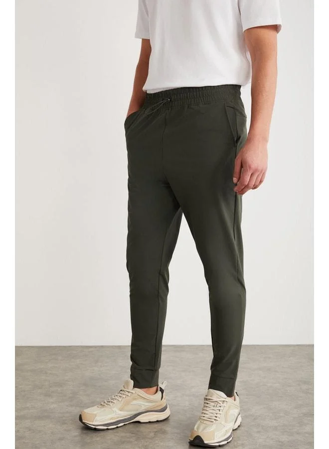 GRIMELANGE Christian Men's Elastic Waist and Stopper-Detail Technical Fabric Green Sweatpants.