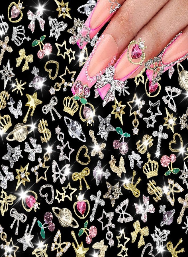 KACHIMOO 120 Pcs Silver Gold Nail Charms 3D Butterfly Cherry Star Bow Cross Planet Crown Heart Dollar Nail Gems Shiny Nail Rhinestones for Women Nail Art DIY Design（21 Styles - Image 1