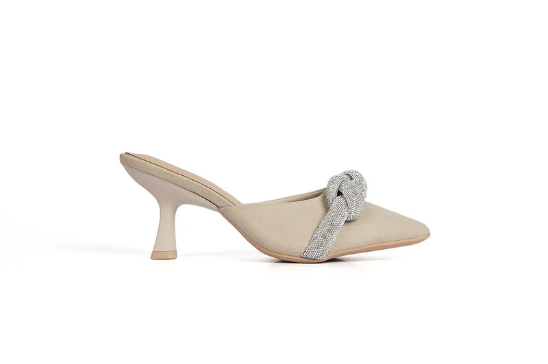The shoe has a pointed toe and a low, slightly tapered stiletto heel