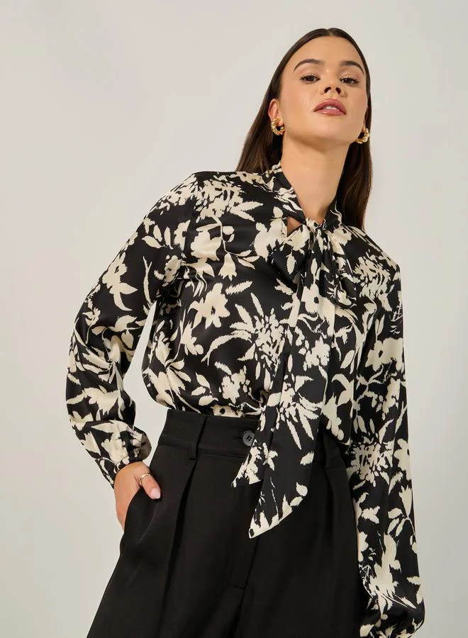 Styli All Over Floral Print Balloon Sleeve Blouse with Tie-Up Neck Detail