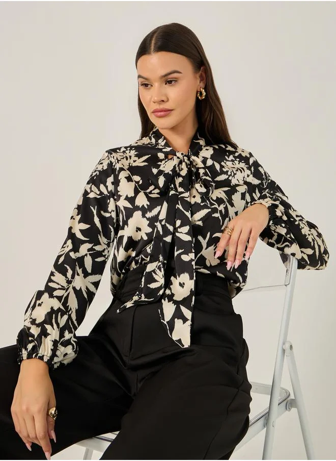 ستايلي All Over Floral Print Balloon Sleeve Blouse with Tie-Up Neck Detail