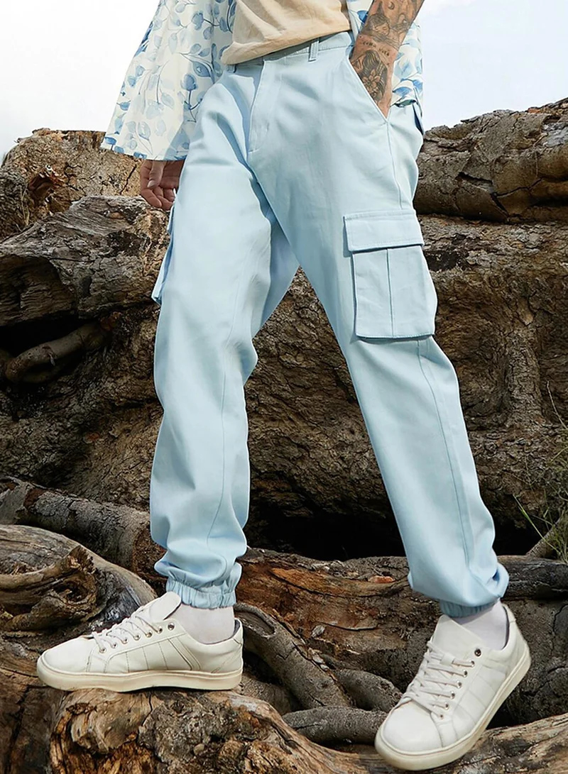 Campus Sutra Campus Sutra Men's Light Blue Cuffed Hem Cargo Trousers For Casual Wear | 6 Pockets | Regular Fit | Button Closure | Cotton Poly Cargo Pant Crafted With Comfort Fit For Everyday Wear