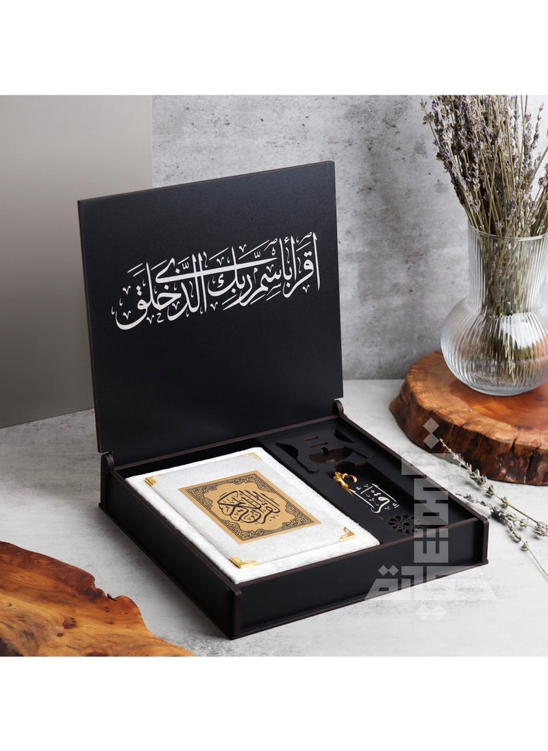 A box of the Holy Qur’an with an incense burner and a Qur’an holder with the Qur’an and a reading break