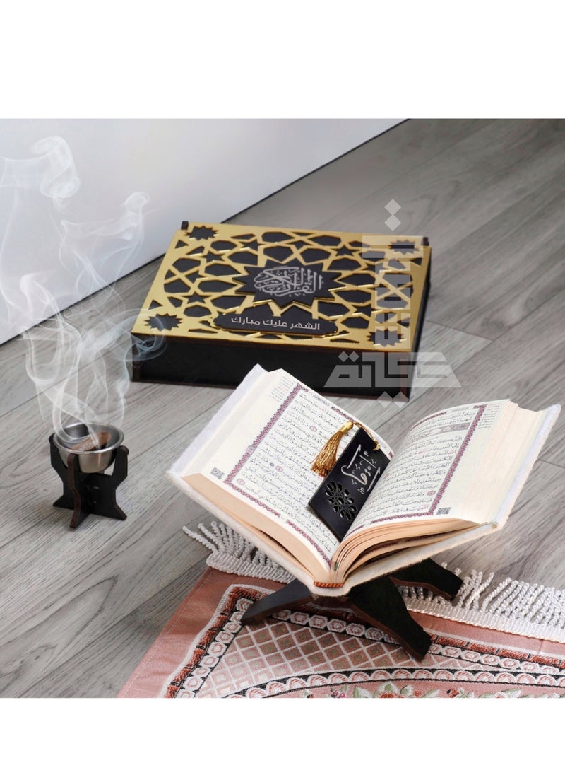 A box of the Holy Qur’an with an incense burner and a Qur’an holder with the Qur’an and a reading break