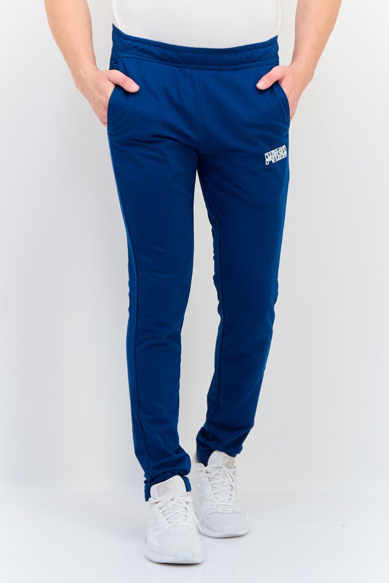 PUMA سروال تدريب ضيق للرجال بشعار العلامة التجارية، أزرق فواتح - Image 1