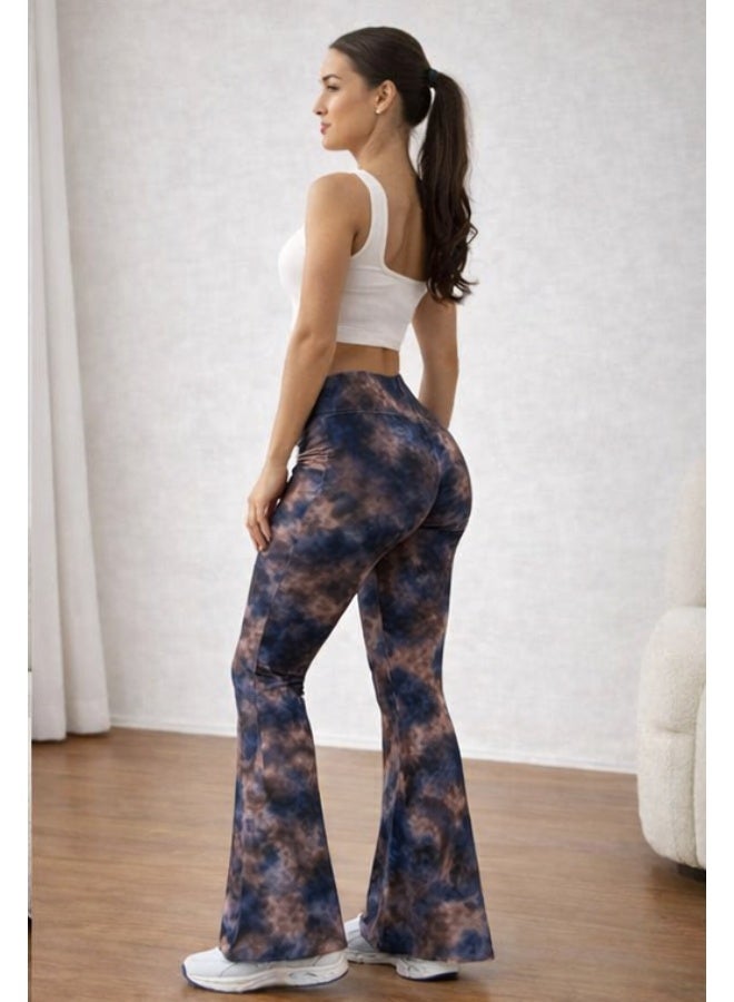 Women's pants with a high waist and a wide cut at the bottom, featuring a modern tie-dye pattern in blue and brown colors. Made from comfortable stretchy fabric suitable for everyday and casual looks. It is styled with a white sleeveless crop top for a chic and trendy look. White sneakers add a youthful and practical touch. Suitable for wearing at home or going out with friends. - Image 3