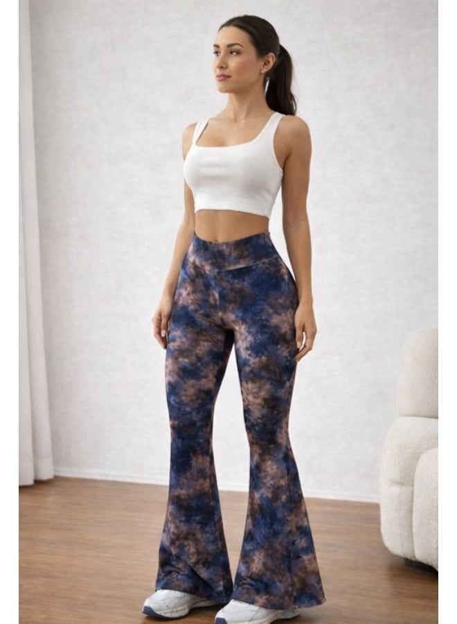 Women's pants with a high waist and a wide cut at the bottom, featuring a modern tie-dye pattern in blue and brown colors. Made from comfortable stretchy fabric suitable for everyday and casual looks. It is styled with a white sleeveless crop top for a chic and trendy look. White sneakers add a youthful and practical touch. Suitable for wearing at home or going out with friends. - Image 4
