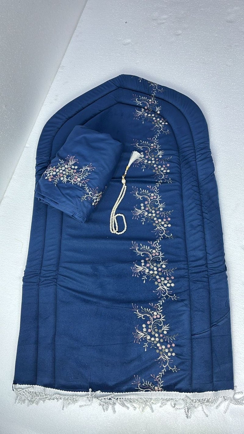 A luxurious 2cm thick dark blue prayer rug with a matching shawl and elegant prayer beads.