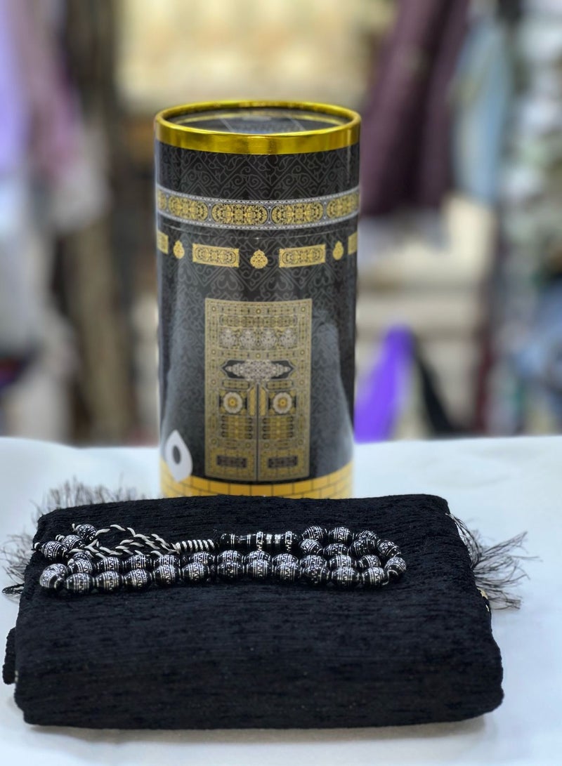 An elegant black gift box inspired by the design of the Kaaba’s Kiswa and the Black Stone, containing a luxurious prayer rug with Islamic motifs and a premium bead misbaha. Perfect for gifting on occasions like Hajj, Umrah, Ramadan, Eid, and other special events. - Image 2
