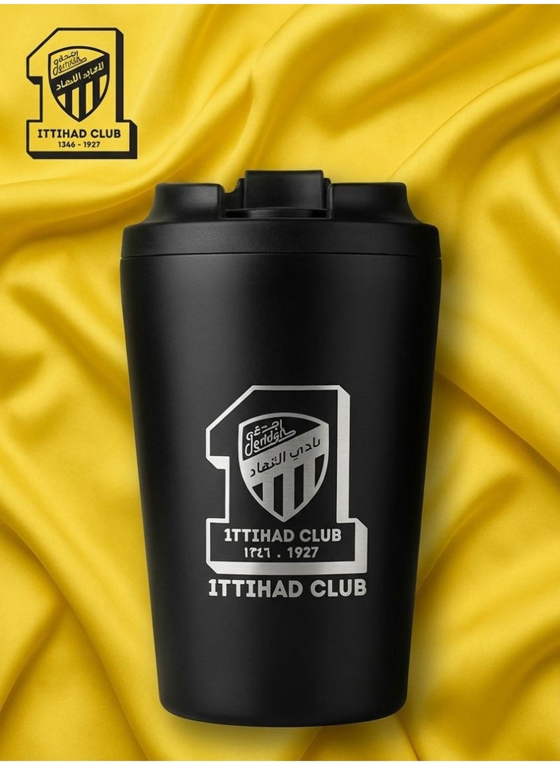 A matte black thermal mug bearing the classic logo of Al-Ittihad Saudi Club - Image 1