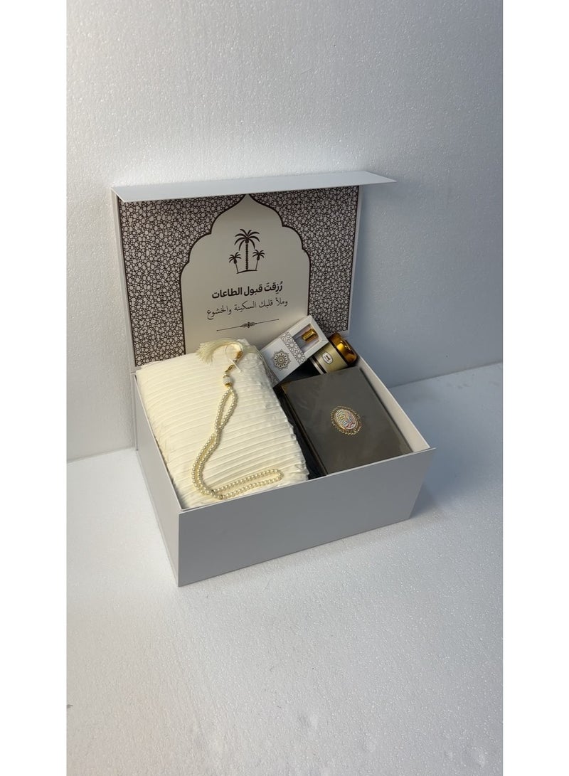 This comprehensive 6-piece prayer set is an elegant and practical gift that combines reverence with comfort; it includes a padded prayer mat, an embroidered prayer garment, a Quran, prayer beads, *Mabthouth* (incense blend), and musk. - Image 1