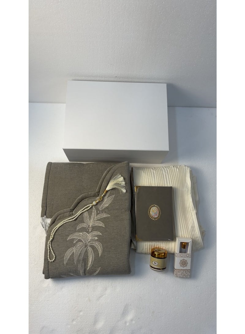This comprehensive 6-piece prayer set is an elegant and practical gift that combines reverence with comfort; it includes a padded prayer mat, an embroidered prayer garment, a Quran, prayer beads, *Mabthouth* (incense blend), and musk. - Image 2