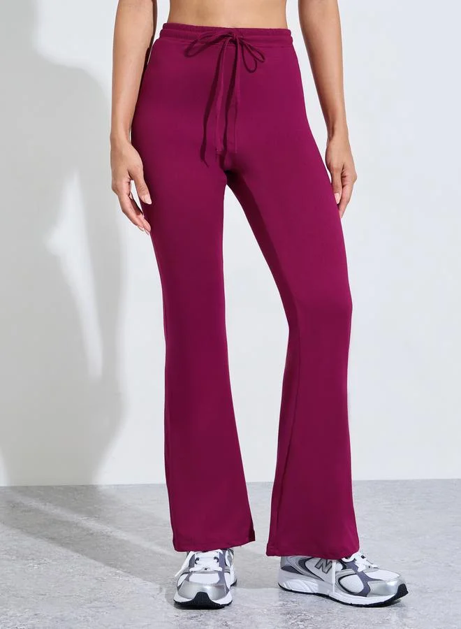 Styli Active  Burgundy Solid Fitted T-Shirt And Flared Pants Active Set for Women | Best Price UAE