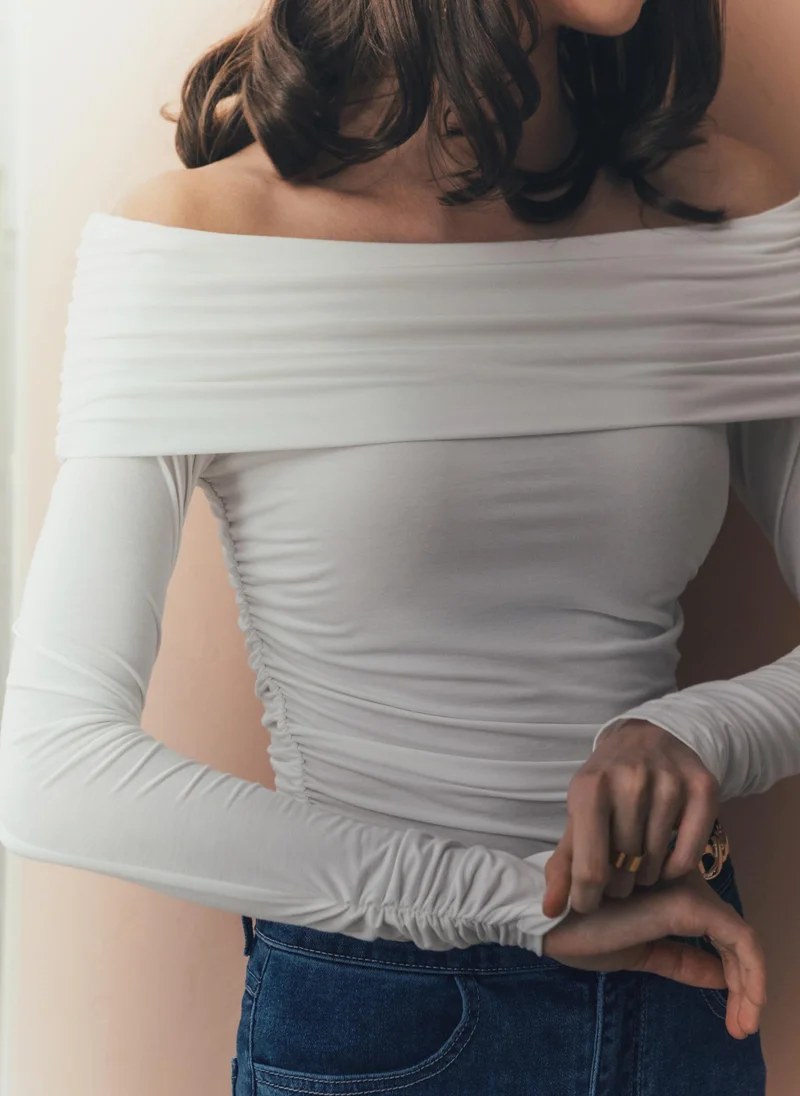 Top with open shoulders and draping on bodice