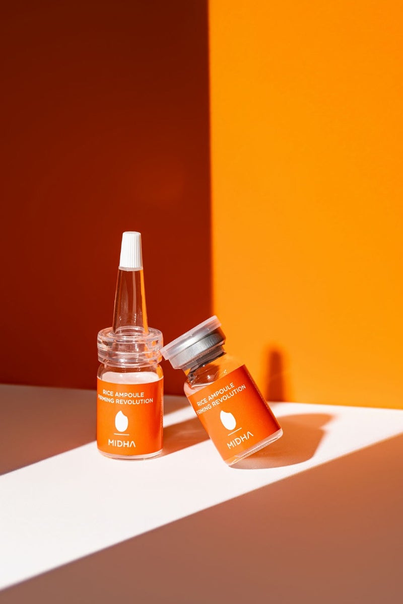 Midha Rice Ampoule Firming Set 7ml x 4 Vials is a firming solution that combines a rice-based serum and a lightweight ampoule, designed to tighten, smooth, and brighten the complexion for a more youthful, wrinkle-free appearance.  Ideal for daily use on all skin types, this vegan-friendly set enhances hydration, and helps protect against environmental stressors—leaving skin visibly firmer and radiant. - Image 1