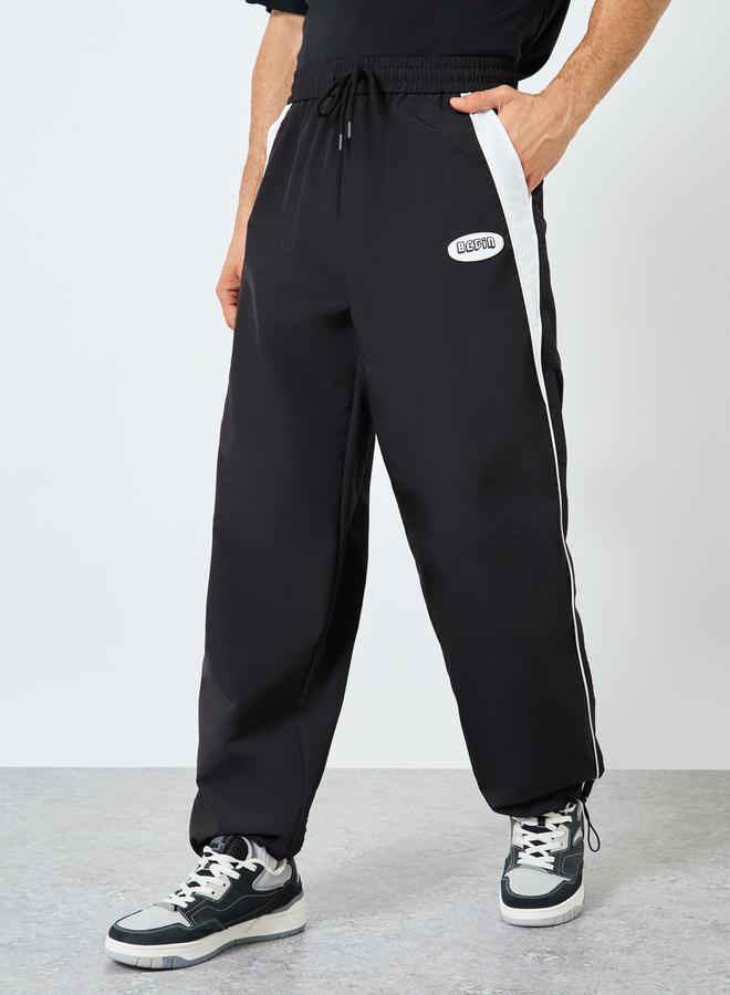 Styli Black Relaxed Fit Joggers with Side Piping and Placement Print - Image 1