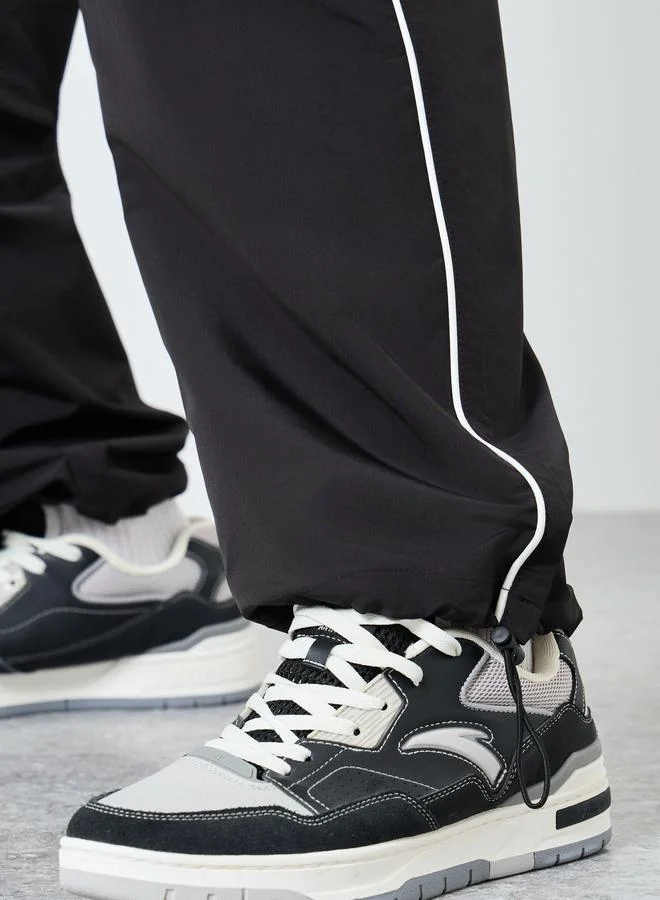 Styli Styli Black Relaxed Fit Joggers with Side Piping and Placement Print