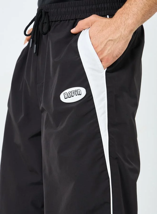 Styli Styli Black Relaxed Fit Joggers with Side Piping and Placement Print