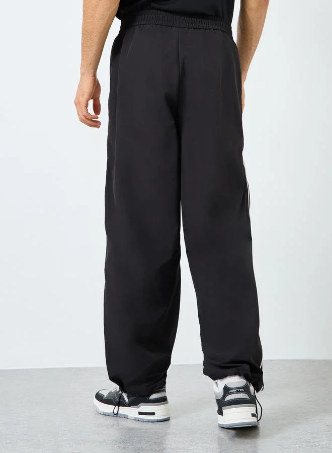 Styli Styli Black Relaxed Fit Joggers with Side Piping and Placement Print