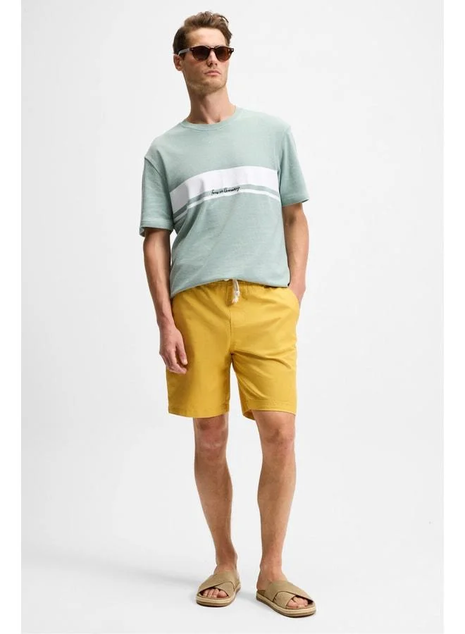 Grimelange LASPER Men's elastane Side Pocket Elastic Waist Relaxed Fit Saffron Yellow Shorts.