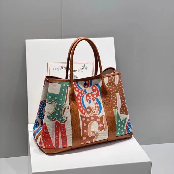 Explosive Canvas Leather Patch Color Garden Bag 2025 Summer Leisure Travel Art Graffiti Shoulder Handbag - Image 1