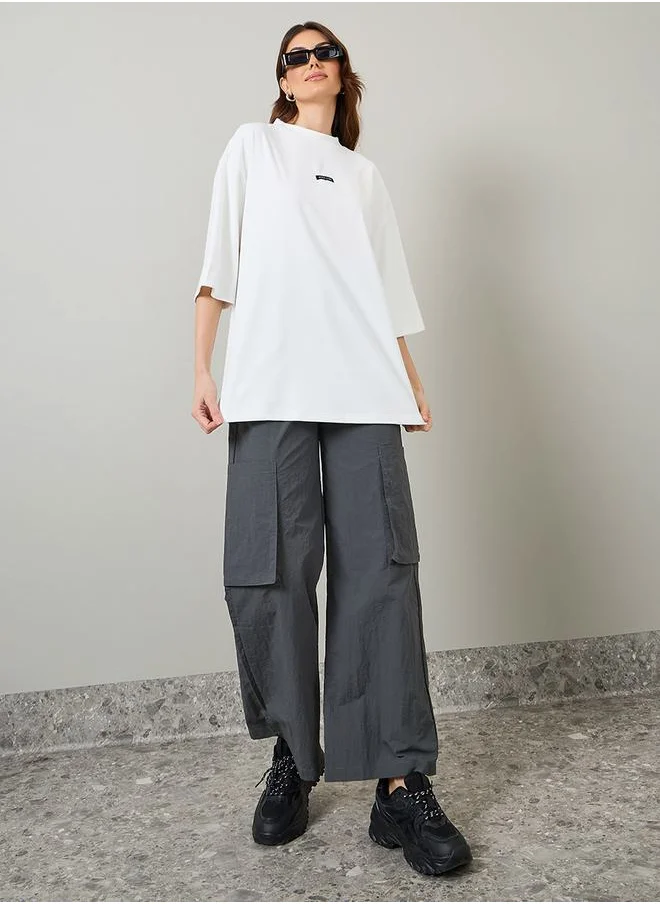 ستايلي Oversized Slogan Patch Detail Longline T-Shirt