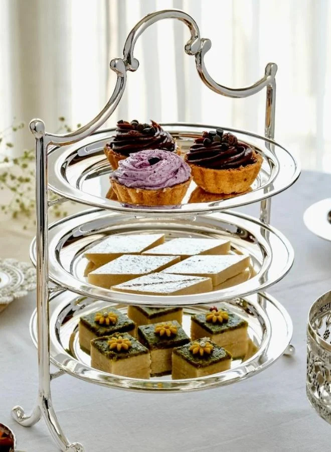 Casa Quesera Add a touch of luxury to your table with this handcrafted 3-tier silver-plated serving platter featuring a solid brass base. Ideal for displaying desserts, snacks, fruits, or appetizers, it’s perfect for high-tea settings, parties, weddings, and festive gatherings. The combination of gleaming  real silver and rich brass offers timeless elegance and lasting durability. A beautiful centerpiece and an excellent gift for weddings, housewarmings, or special occasions.