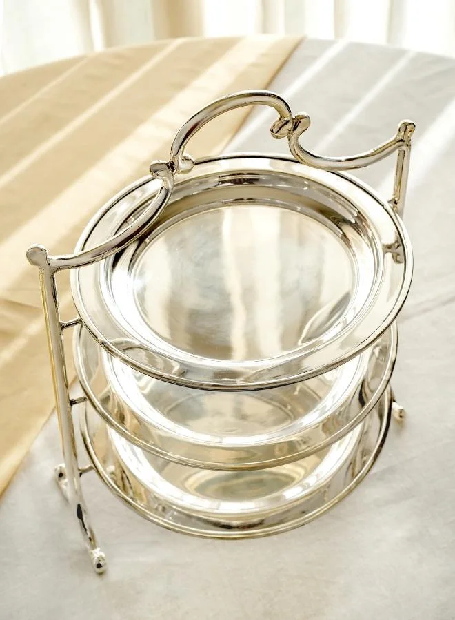 Casa Quesera Add a touch of luxury to your table with this handcrafted 3-tier silver-plated serving platter featuring a solid brass base. Ideal for displaying desserts, snacks, fruits, or appetizers, it’s perfect for high-tea settings, parties, weddings, and festive gatherings. The combination of gleaming  real silver and rich brass offers timeless elegance and lasting durability. A beautiful centerpiece and an excellent gift for weddings, housewarmings, or special occasions.