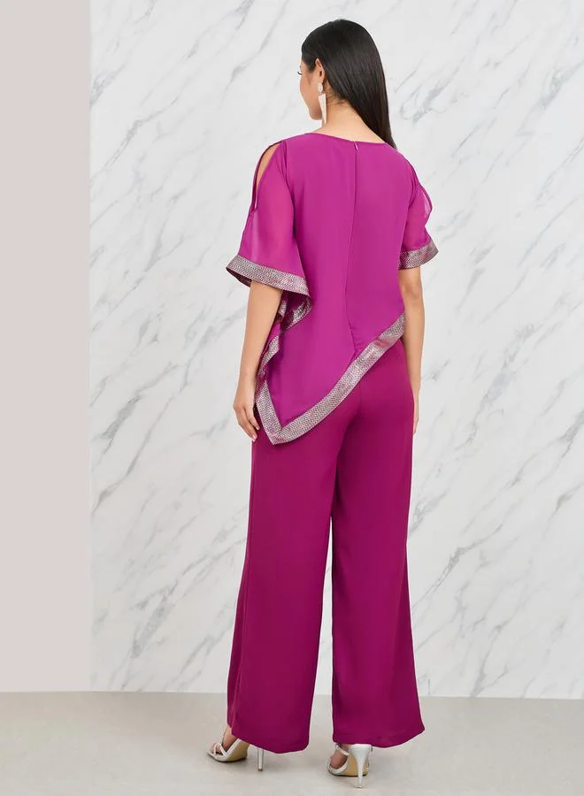 Styli Lace Trim Asymmetric Hem Cape Overlay Wide Leg Jumpsuit