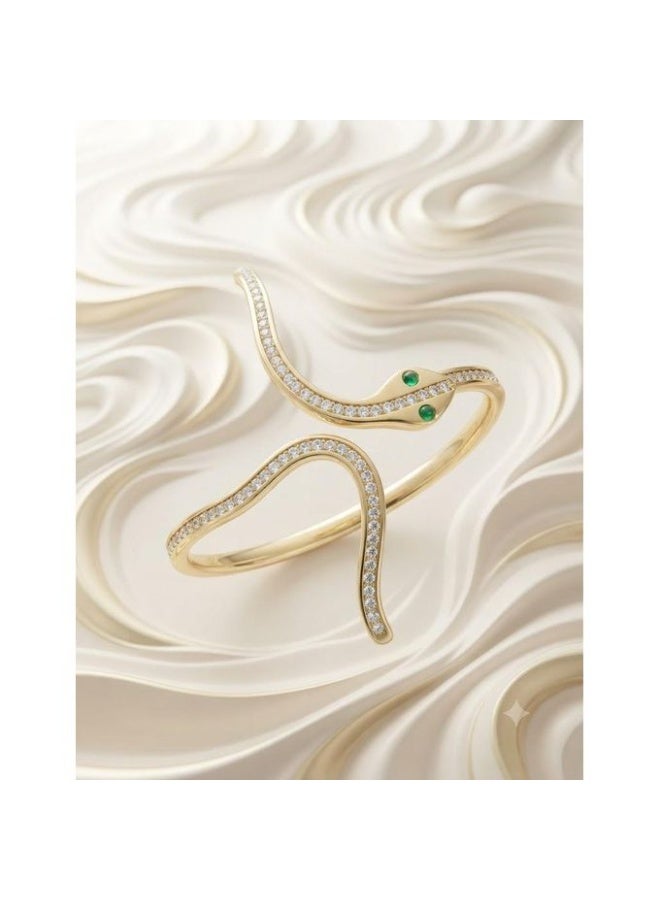 Gold Finish Serpentine Stainless Steel Bangle with Pavé Crystals and Green Gemstone Eyes