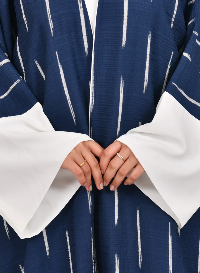 HAWRAA ABAYA Navy blue wide sleeve abaya with white stripes and white dress