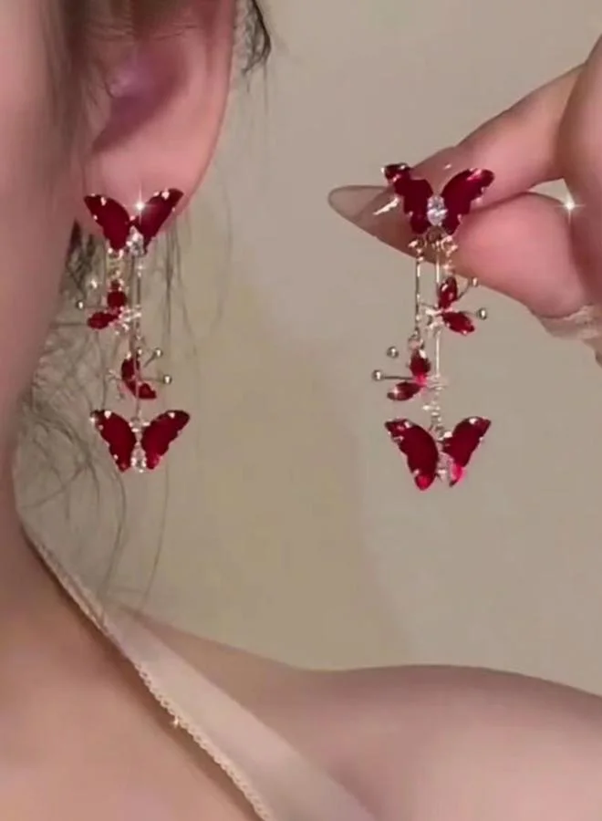 تايك تو أقراط متدلية على شكل فراشة بلون خمري