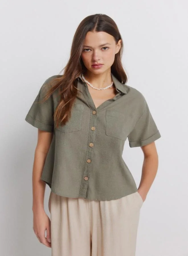 Springfield Linen shirt. Short folded sleeve. V-neck shirt collar. Front buttons. Patch pockets.