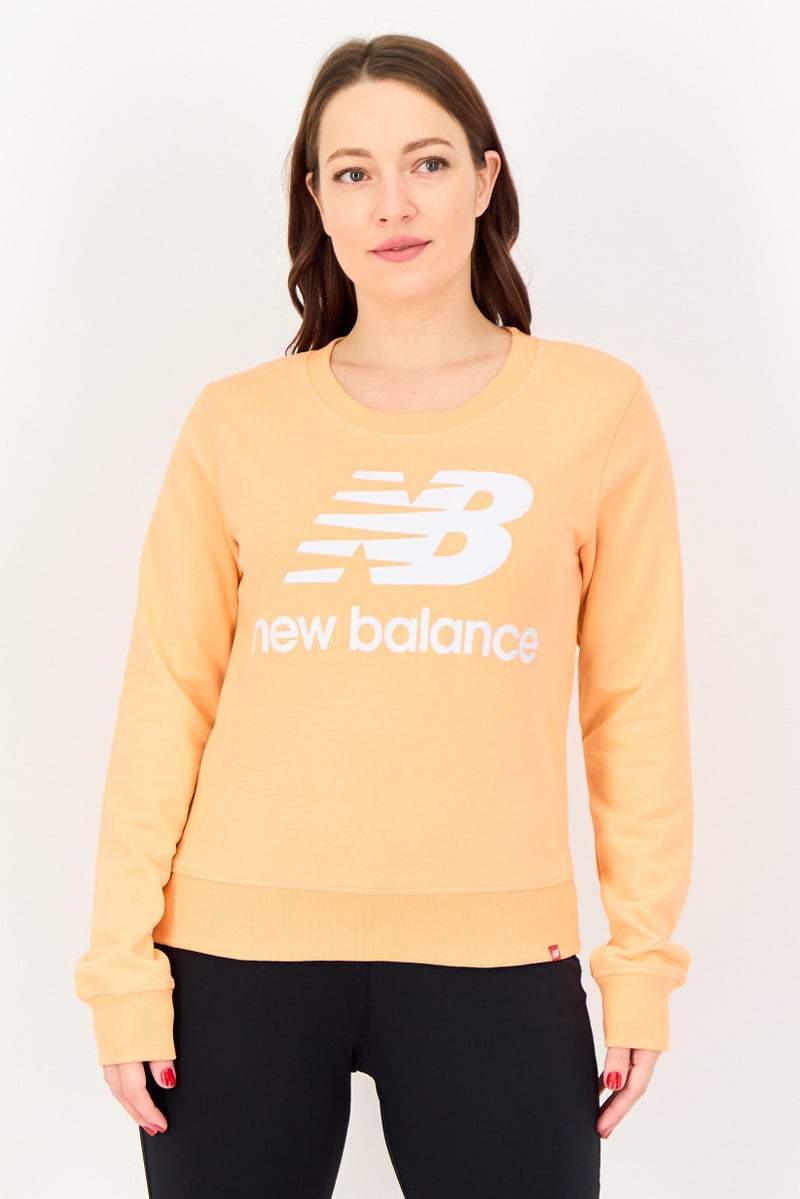 New Balance Women Relaxed Fit Long Sleeve Outdoor Sweatshirt, Peach - Image 1