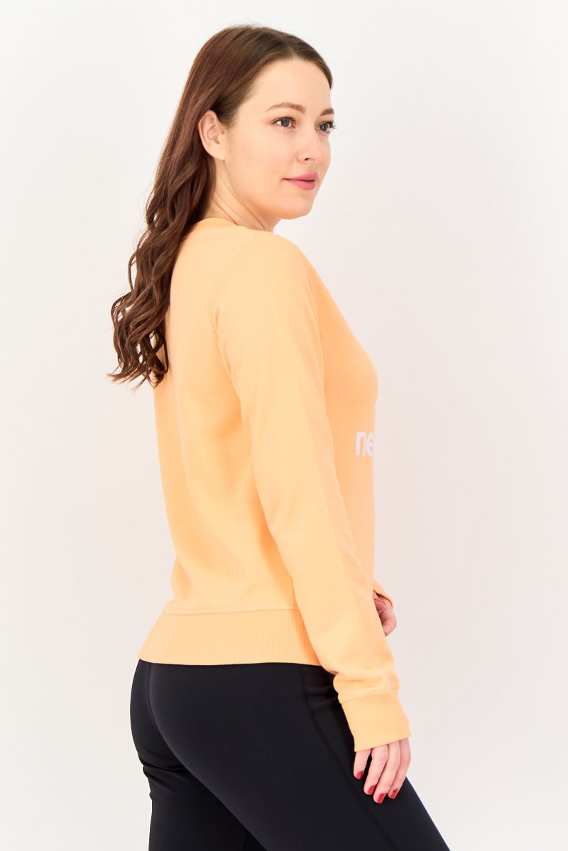 New Balance Women Relaxed Fit Long Sleeve Outdoor Sweatshirt, Peach - Image 3