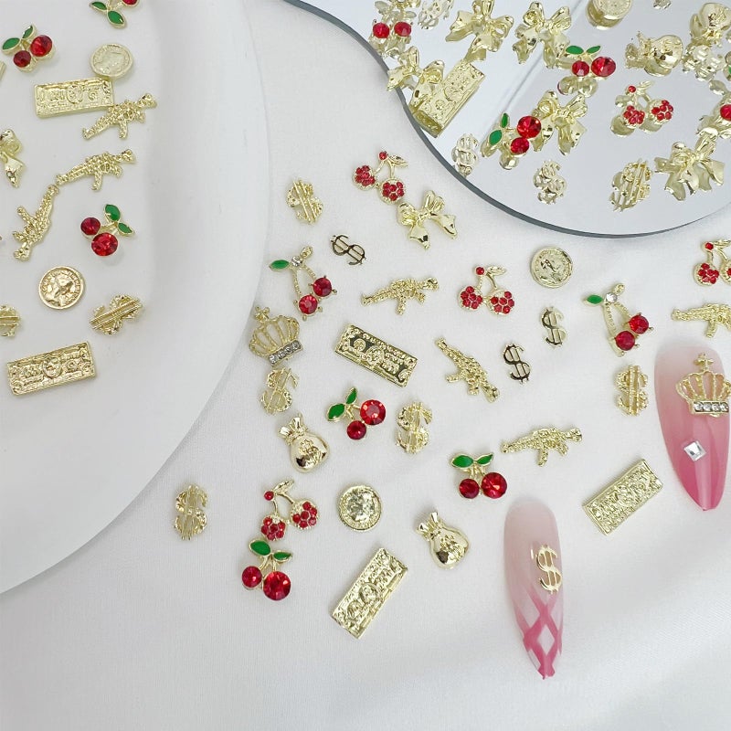 Pizadix 106 Pcs Gold Nail Charms with Dollars Sign, Coins, Cherries, Crowns, Guns and Bows for Nail Art Decoration Jewelry - Image 2