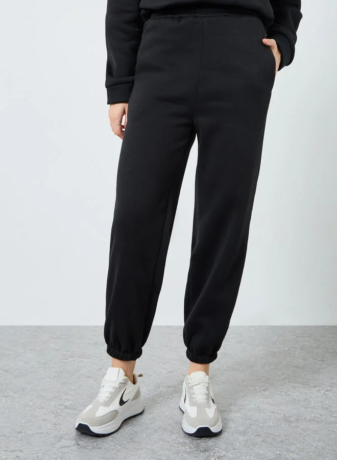 ستايلي طقم بلوزة بسحاب وبنطلون رياضي مضلع